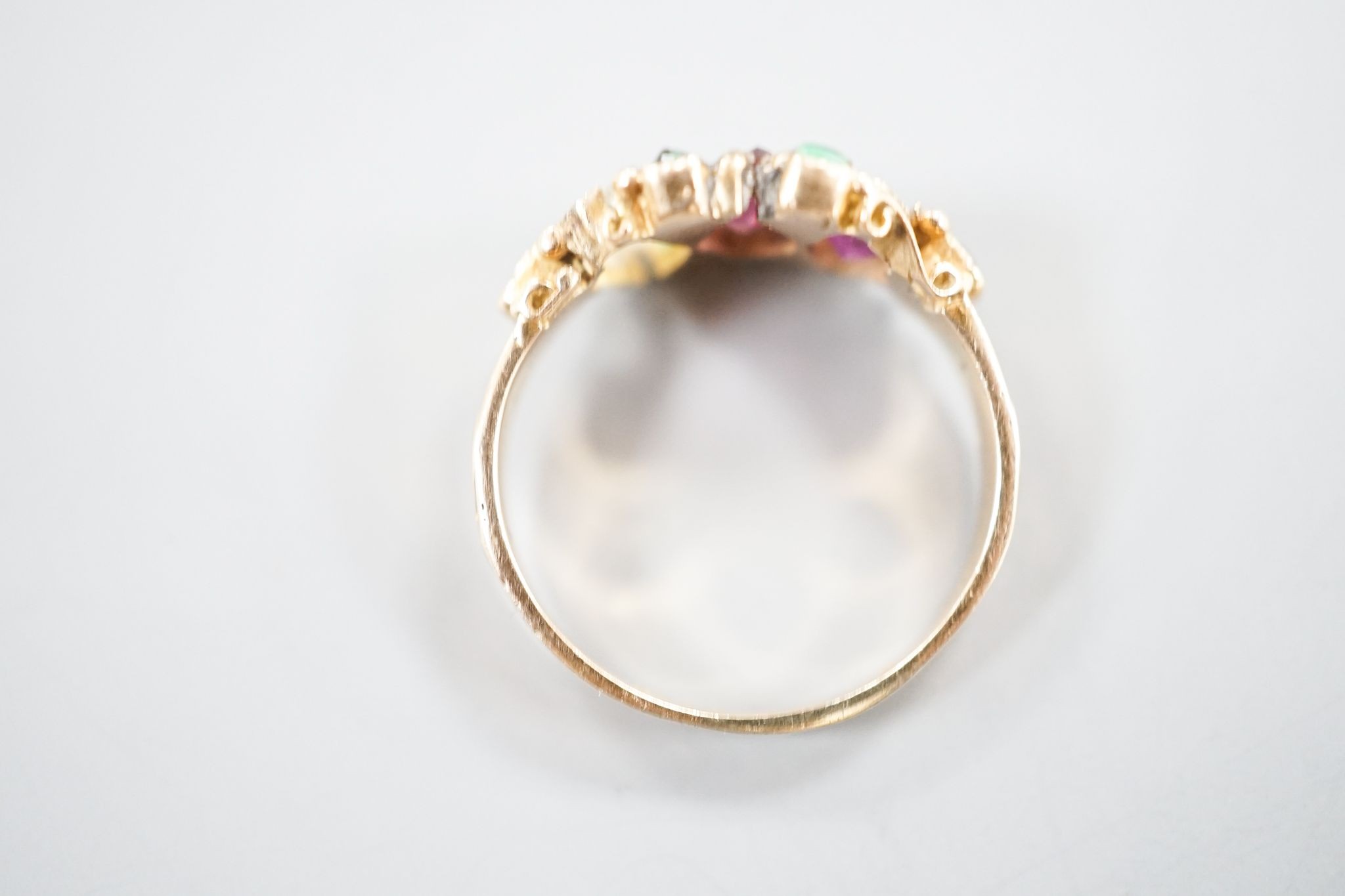 A late Victorian 15ct gold, garnet and emerald set dress ring(stone missing & stone replacement?), size L, gross 2.2grams.
